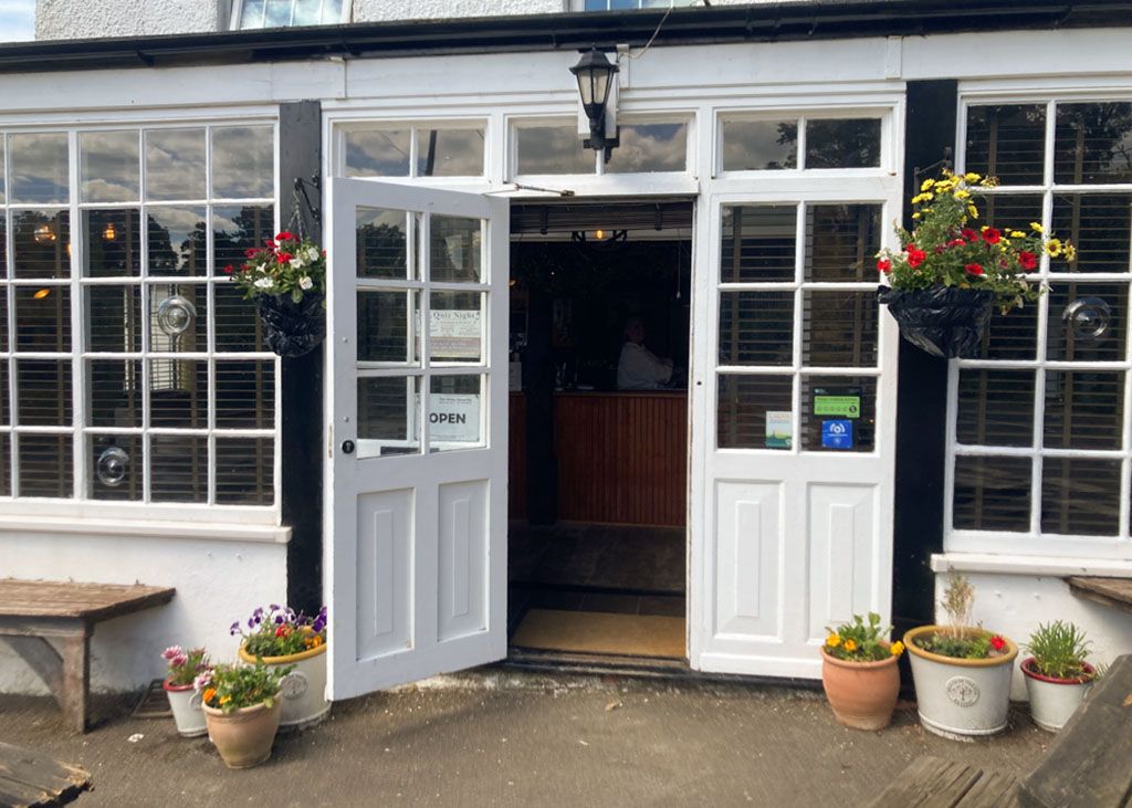The front door of the White Horse Inn, with hanging baskets