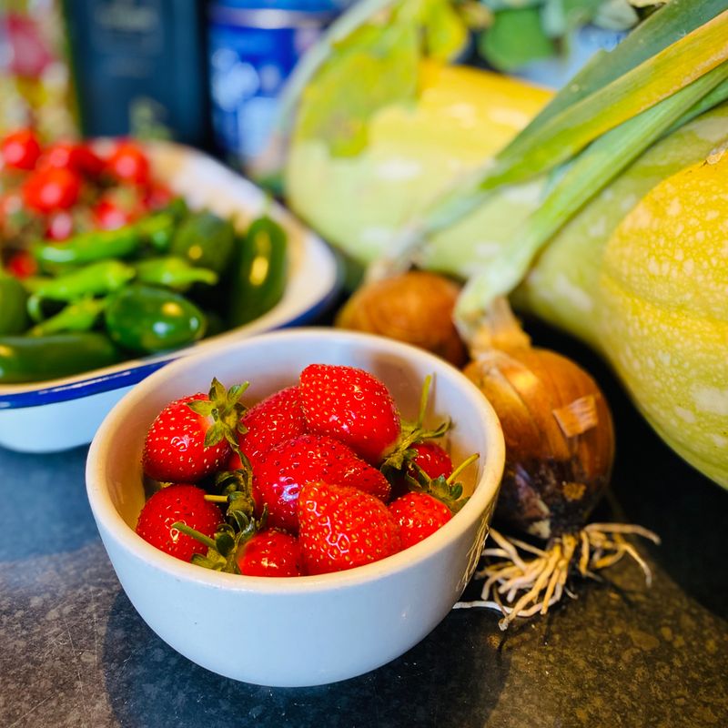 Fresh strawberries, leaves and vegetables