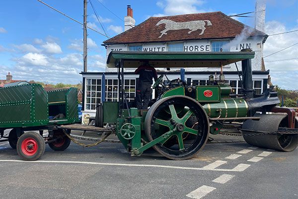 A steam roller parked outside the White Horse Inn
